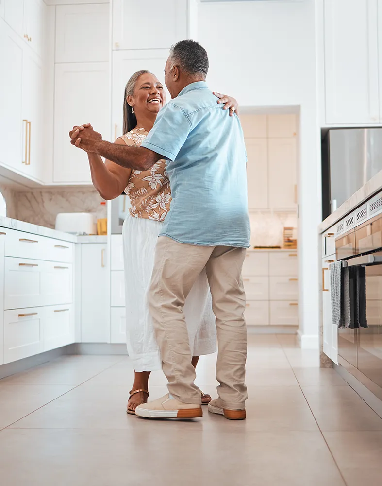 Senior couple walking hand in hand on a gravel path